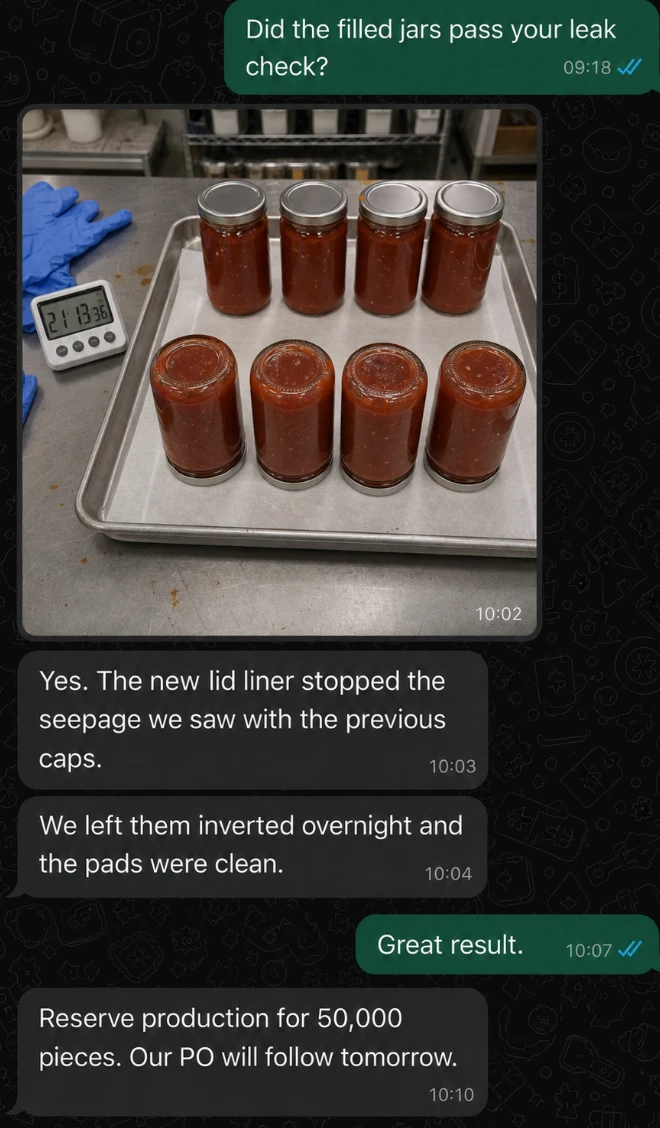 WhatsApp conversation showing filled sauce jars inverted for a leak test, confirming the new lid liner passed and production reserved for 50,000 pieces.